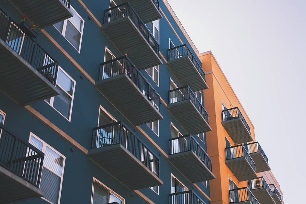 A modern Sunbelt multifamily apartment community under a warm evening sky.