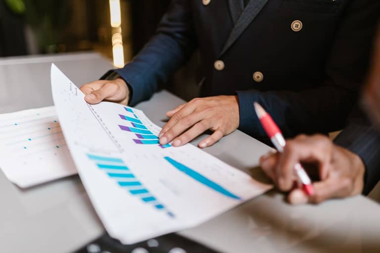 What Good Investor Reporting Actually Looks Like (With a Real Example) An investor reviewing quarterly performance charts and property-level financials.